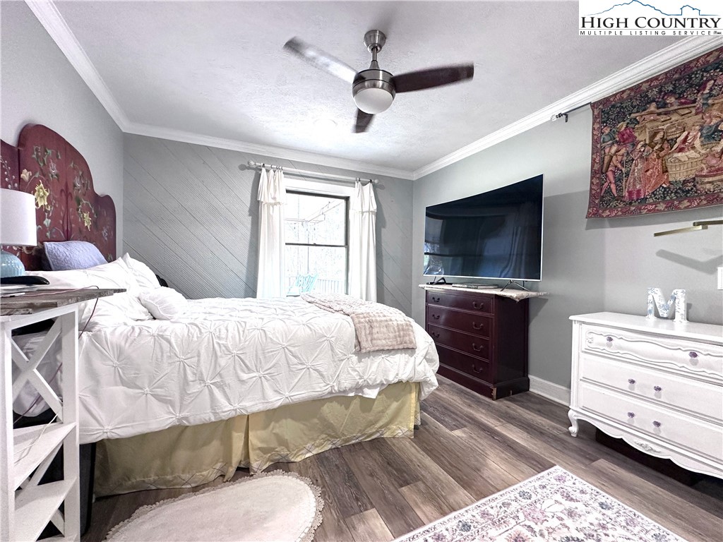 223 Timberlake Sparta, NC 28675 - Photo 27 of 50 a bedroom with a bed and a flat screen tv