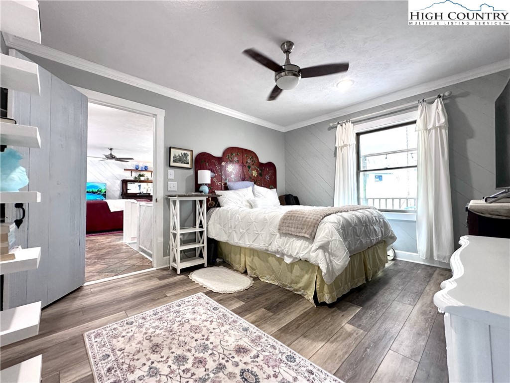 223 Timberlake Sparta, NC 28675 - Photo 28 of 50 a bedroom with a bed wooden floor and window