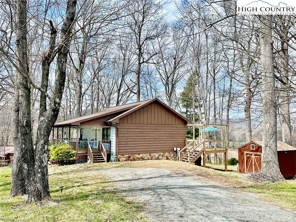 223 Timberlake Sparta, NC 28675 - Photo 3 of 50 a white house that has a tree in front of it