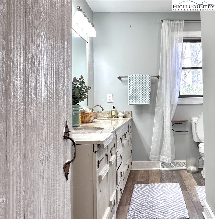 223 Timberlake Sparta, NC 28675 - Photo 31 of 50 a bathroom with a sink a mirror and a shower