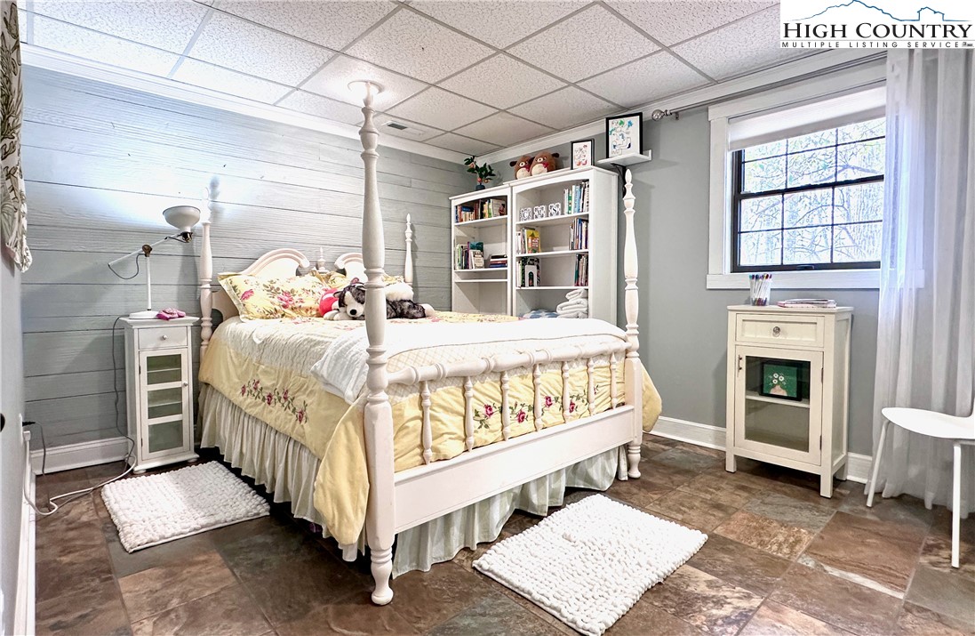 223 Timberlake Sparta, NC 28675 - Photo 35 of 50 a bedroom with a bed and a fireplace