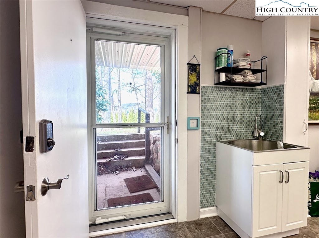 223 Timberlake Sparta, NC 28675 - Photo 43 of 50 a kitchen with white cabinets and clock on the wall