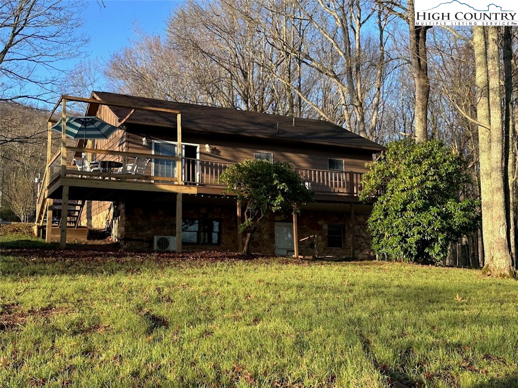 223 Timberlake Sparta, NC 28675 - Photo 46 of 50 a view of a house with a large window and a yard