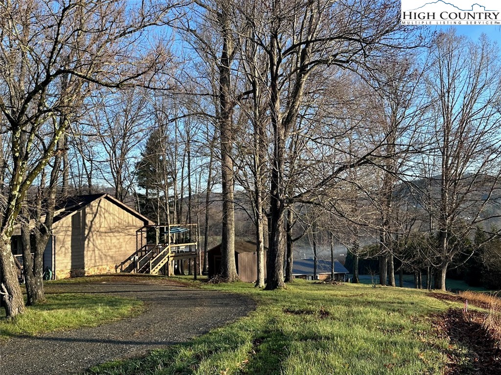223 Timberlake Sparta, NC 28675 - Photo 47 of 50 a view of a yard with a house and trees in the background