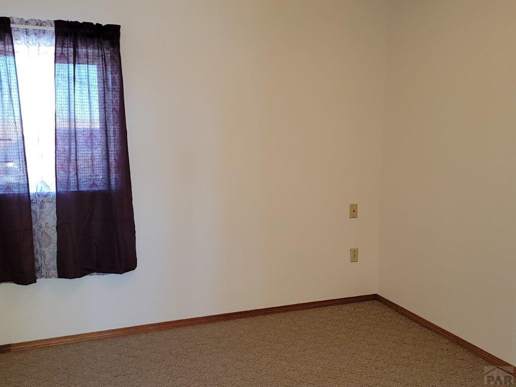 2034 County Rd LL Wiley, CO 81092 - Photo 11 of 29 an empty room with a window