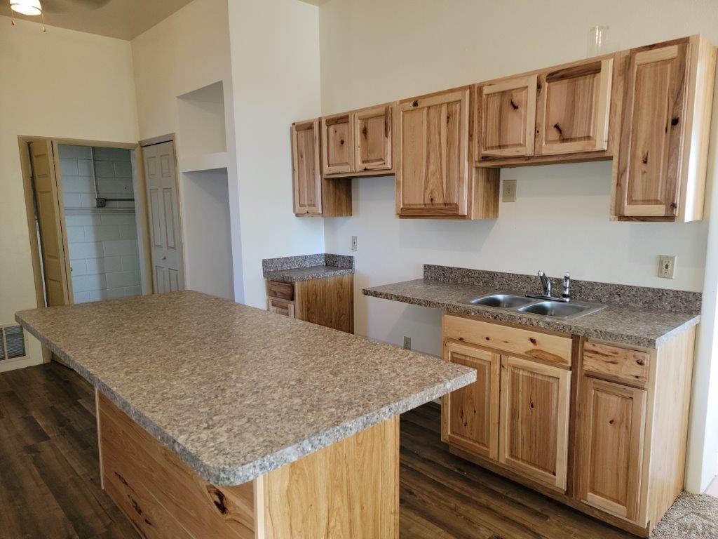 2034 County Rd LL Wiley, CO 81092 - Photo 18 of 29 a kitchen with stainless steel appliances granite countertop a stove sink and cabinets