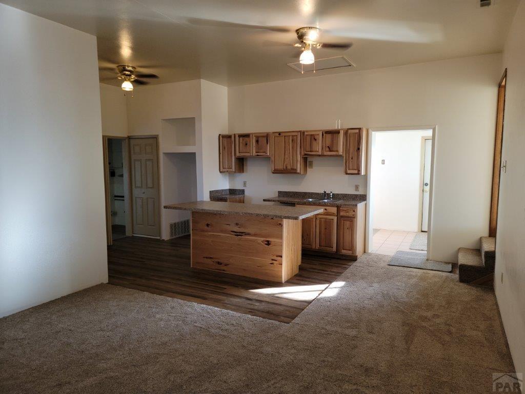 2034 County Rd LL Wiley, CO 81092 - Photo 19 of 29 a kitchen with stainless steel appliances a stove and a refrigerator