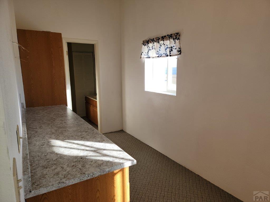 2034 County Rd LL Wiley, CO 81092 - Photo 20 of 29 an empty room with windows