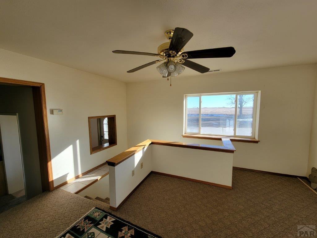 2034 County Rd LL Wiley, CO 81092 - Photo 8 of 29 a room with a bed and a window