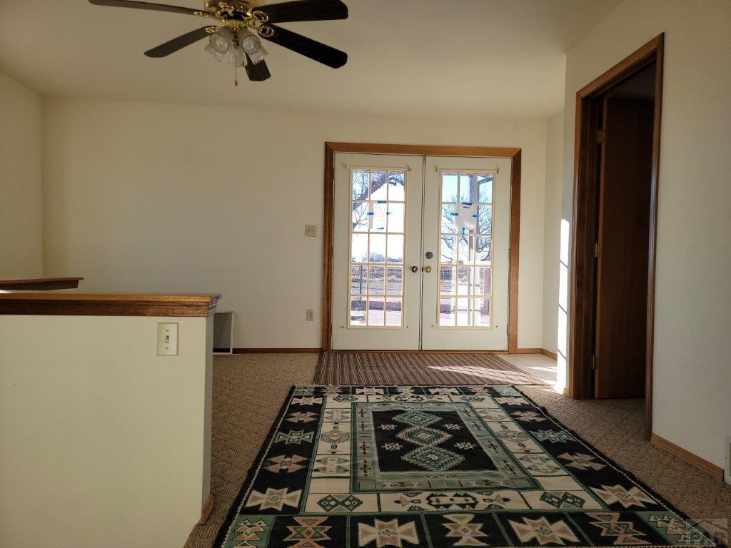 2034 County Rd LL Wiley, CO 81092 - Photo 9 of 29 a view of a livingroom with wooden floor and white walls