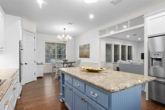 a bathroom with a granite countertop sink and a large mirror