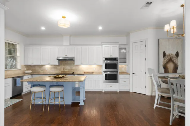 a kitchen with wooden floors and appliances