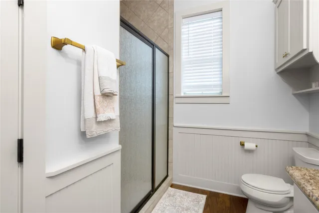 a bathroom with a toilet and a shower