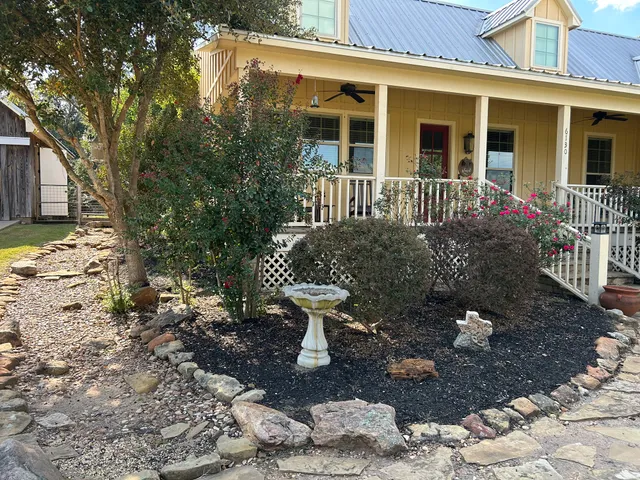 a view of a house with a yard and sitting area