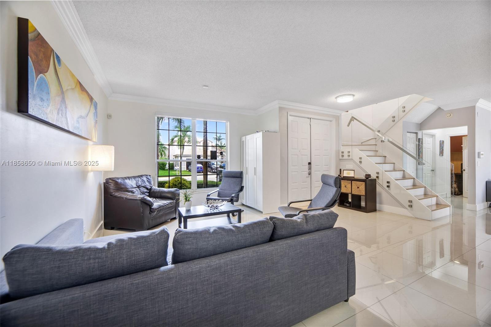 18196 Southwest 29th Street Miramar, FL 33029 - Photo 12 of 54 a living room with furniture and a chandelier