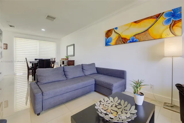 a living room with furniture and flowers