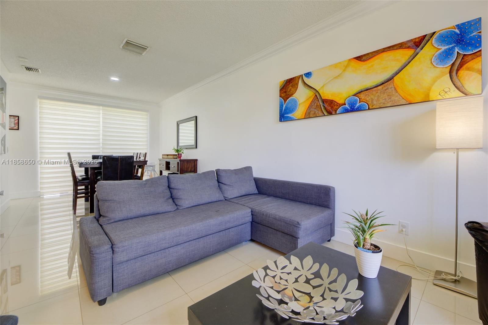 18196 Southwest 29th Street Miramar, FL 33029 - Photo 13 of 54 a living room with furniture and flowers