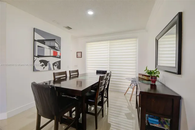 a view of a dining room with furniture and window