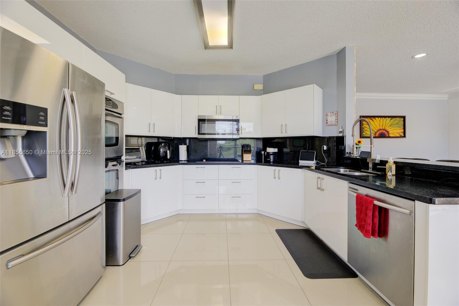 18196 Southwest 29th Street Miramar, FL 33029 - Photo 23 of 54 a large kitchen with stainless steel appliances and a refrigerator