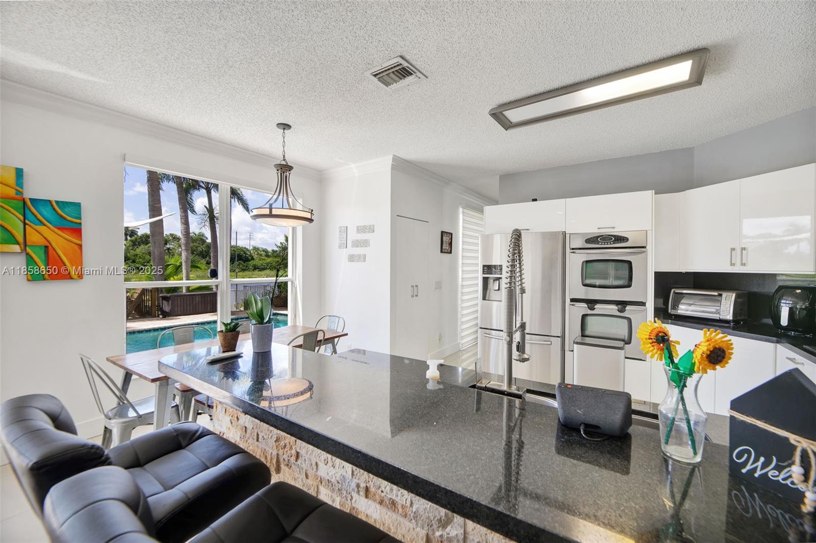18196 Southwest 29th Street Miramar, FL 33029 - Photo 26 of 54 a view of a dining room with furniture a chandelier and wooden floor