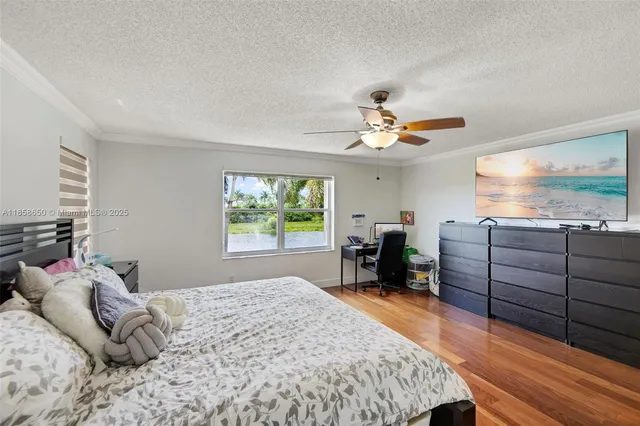 a bedroom with furniture and a large window
