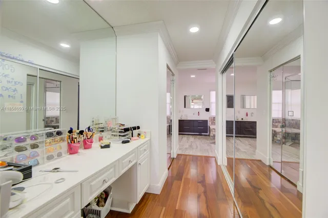 a en suite bathroom with double vanity sinks a large mirror and a shower