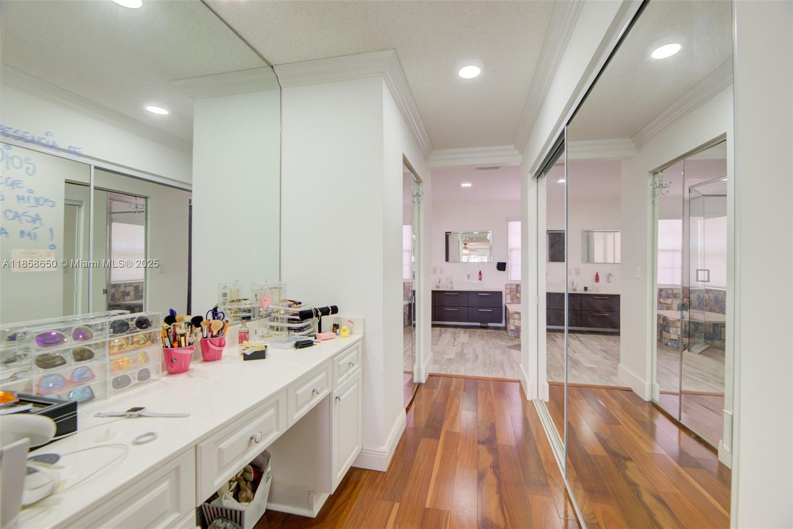 18196 Southwest 29th Street Miramar, FL 33029 - Photo 31 of 54 a en suite bathroom with double vanity sinks a large mirror and a shower