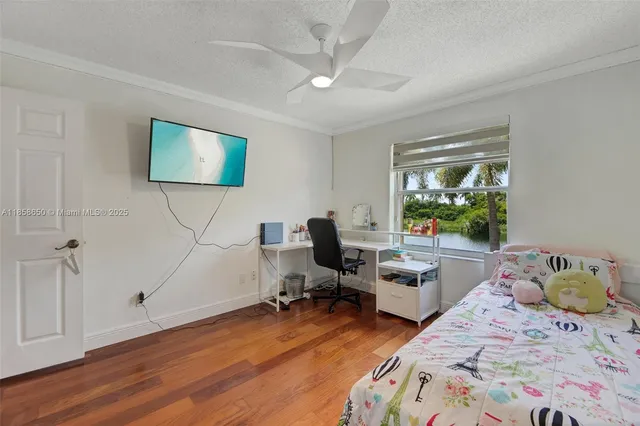 a bedroom with a bed dresser and a window