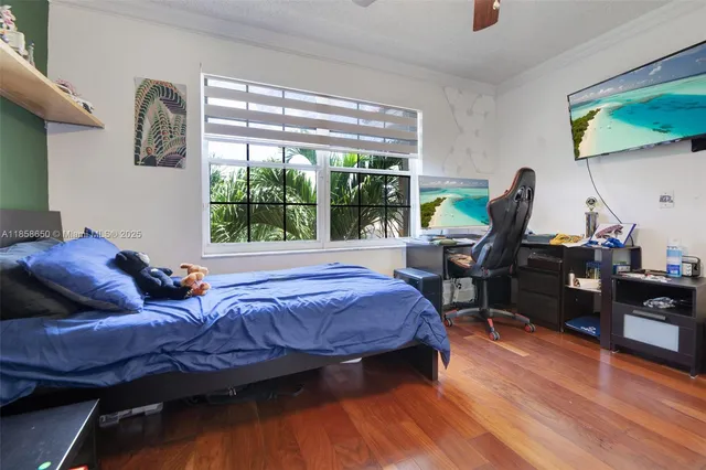 a bedroom with furniture toys ceiling fan and a window