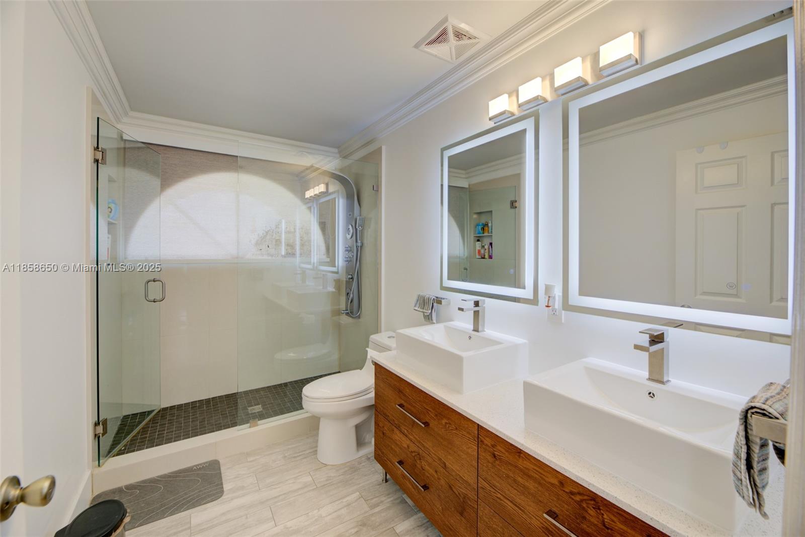 18196 Southwest 29th Street Miramar, FL 33029 - Photo 40 of 54 a bathroom with a double vanity sink mirror and toilet