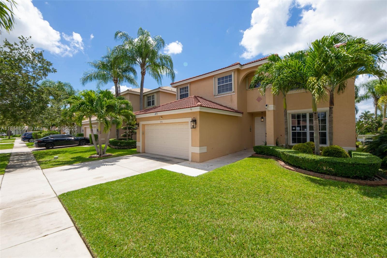 18196 Southwest 29th Street Miramar, FL 33029 - Photo 4 of 54 a front view of a house with a yard and garage