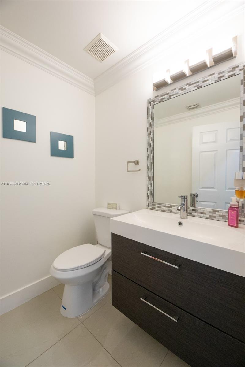 18196 Southwest 29th Street Miramar, FL 33029 - Photo 42 of 54 a bathroom with a toilet a sink and mirror