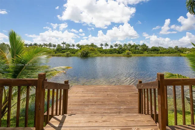 a view of a house with swimming pool and porch