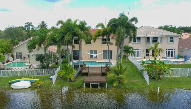 a house with a big yard and potted plants