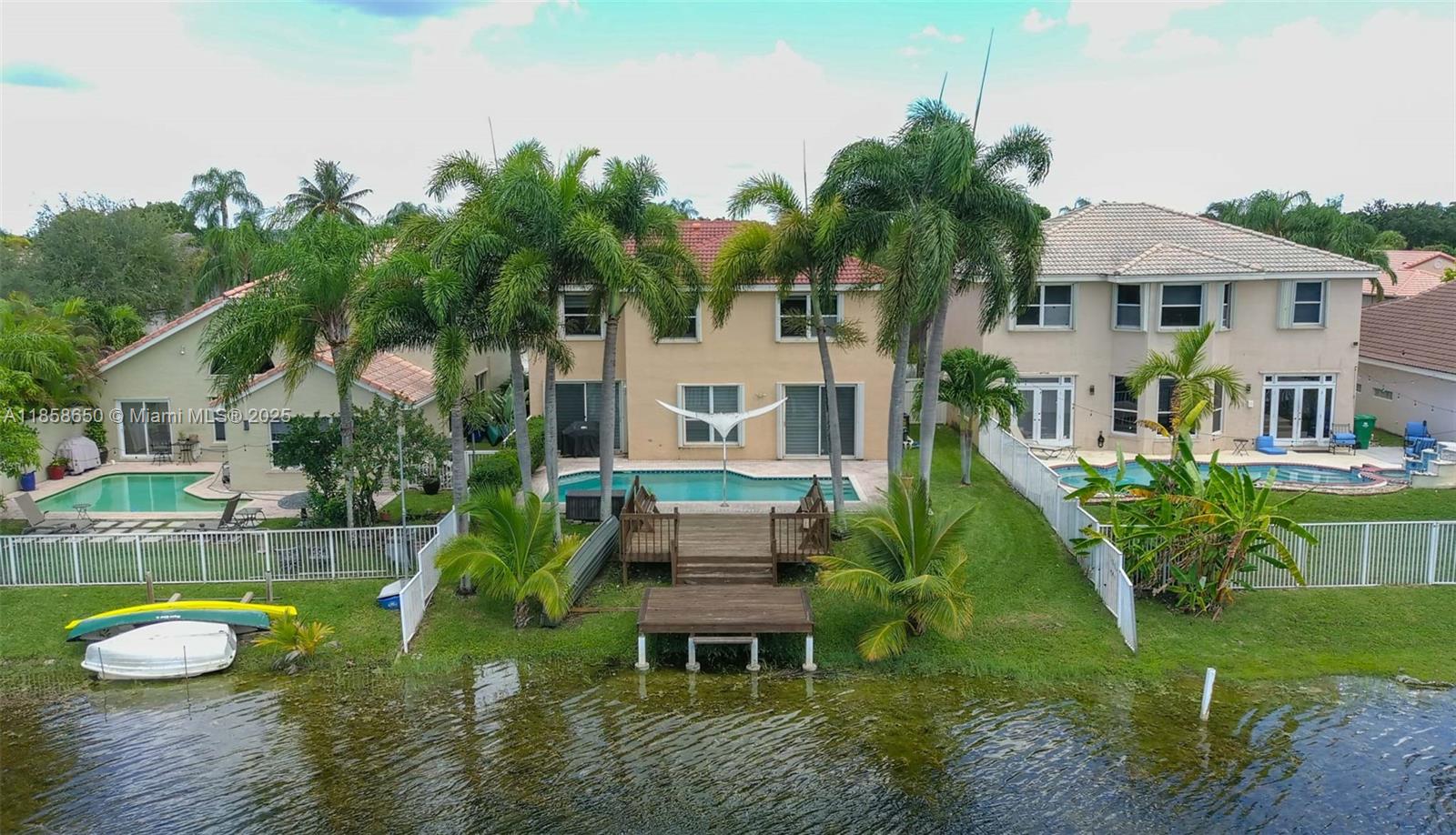 18196 Southwest 29th Street Miramar, FL 33029 - Photo 10 of 54 a house with a big yard and potted plants