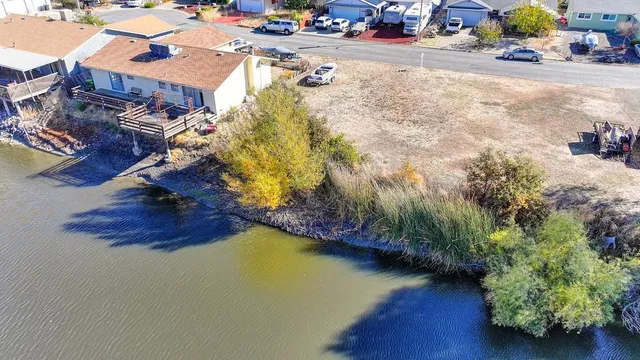 an aerial view of a house with a yard basket ball court and outdoor seating