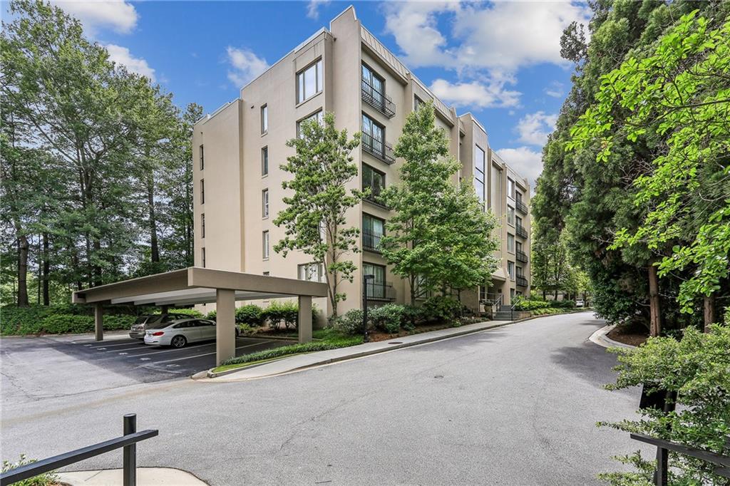 2769 Peachtree Road Northeast, Unit 2 Atlanta, GA 30305 - Photo 1 of 5 a front view of a house with a yard and trees