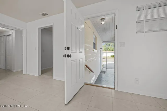 a view of a hallway with a room