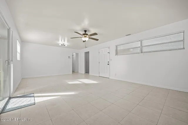 a view of a livingroom with a ceiling fan and window