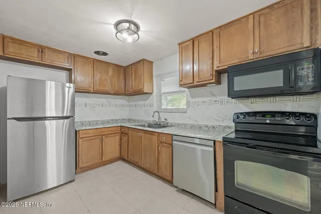 a kitchen with cabinets stainless steel appliances and a sink