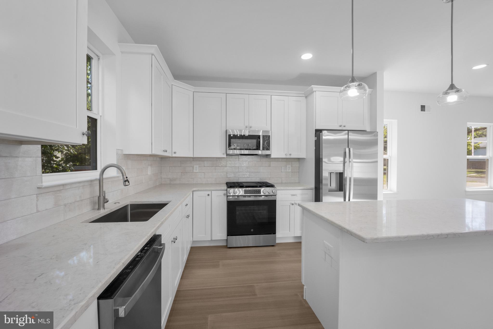 492 Ellis Avenue Lawnside, NJ 08045 - Photo 11 of 33 a kitchen with stainless steel appliances granite countertop a sink stove and refrigerator