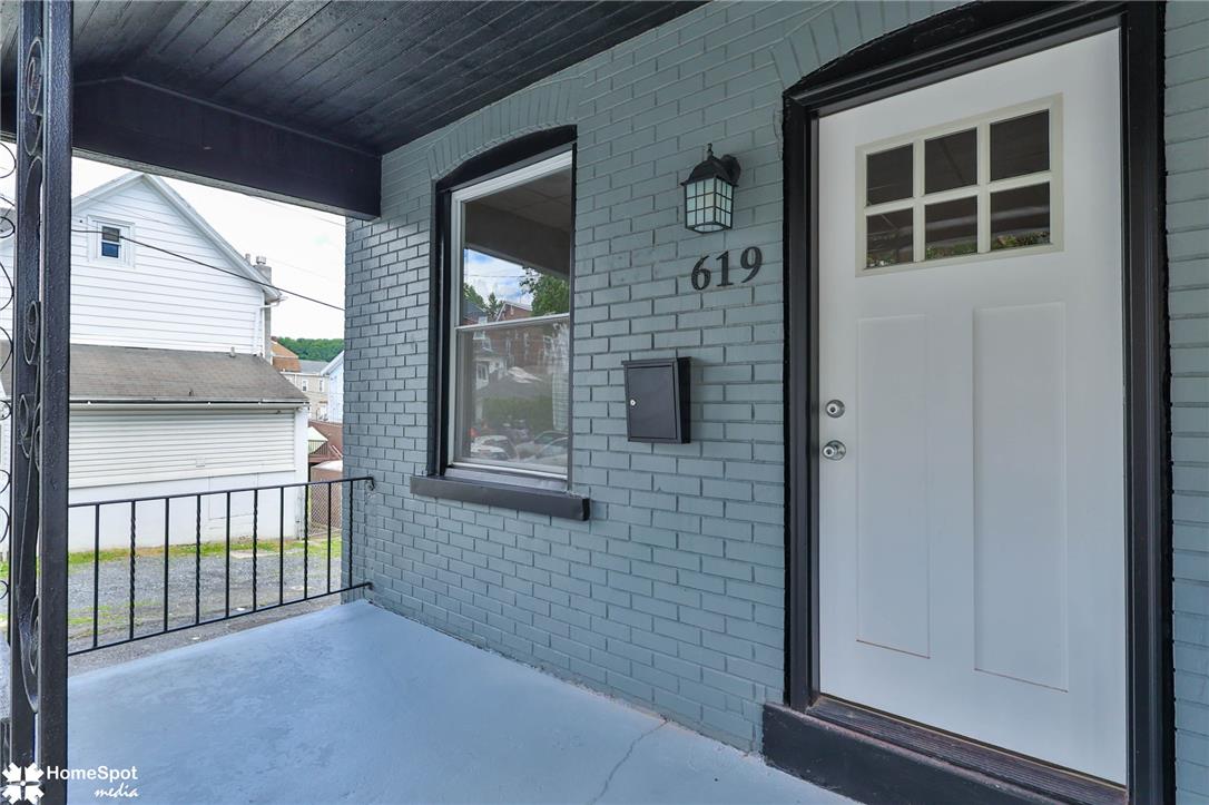 619 Sioux Street Bethlehem, PA 18015 - Photo 2 of 61 A welcoming brick exterior greets visitors with a cozy covered porch and wrought iron railings.