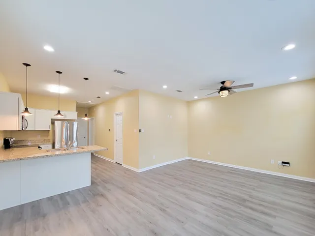 a view of a kitchen with a sink and a refrigerator