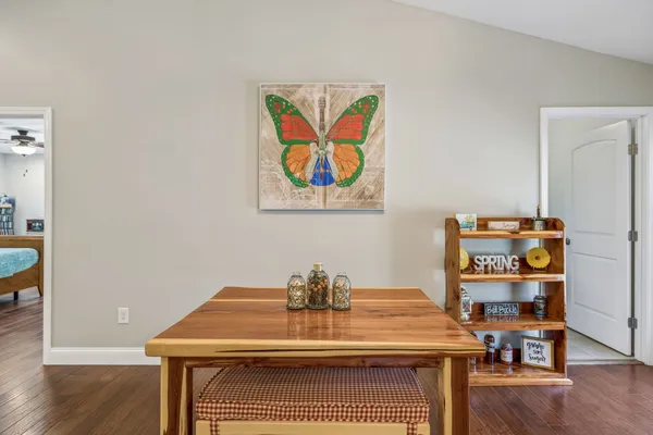 a room with a table and a painting on the wall