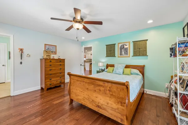 a bed room with a bed and a ceiling fan