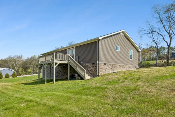 a house with huge green field in front of it