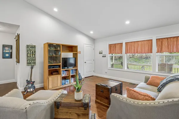 a living room with furniture and large window