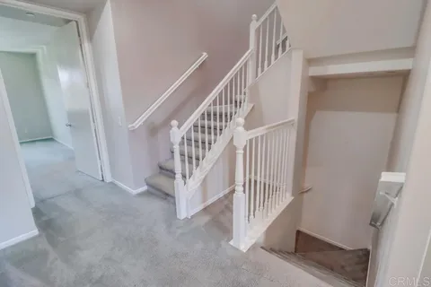 a view of staircase with white walls and windows
