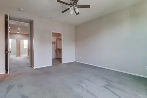 a view of a livingroom with a ceiling fan and window