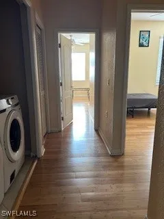 a view of a hallway with wooden floor